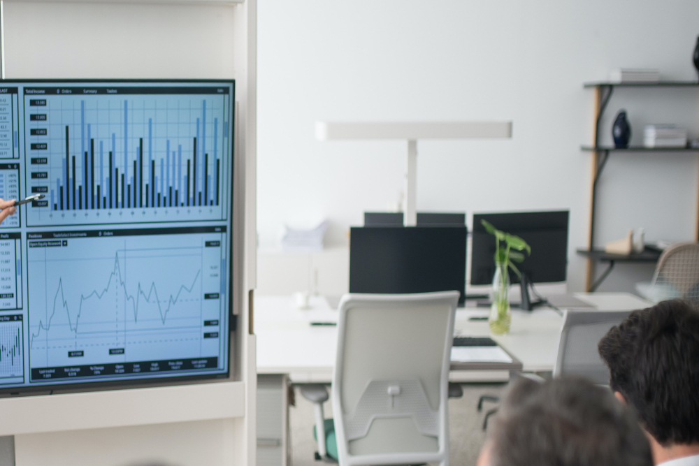 Computer screen in board room with analytics presentation. Liam Hennessy, Digital Strategist